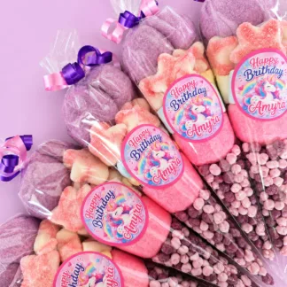 Personalised unicorn candy cones with pink and purple sweets for a birthday party